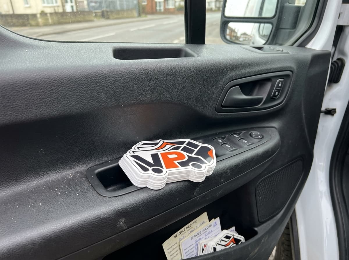 Stack of boiler stickers stored neatly inside Ford Transit van door pocket